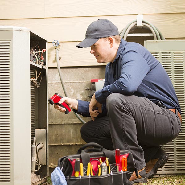 Air conditioner repairmen work on home unit