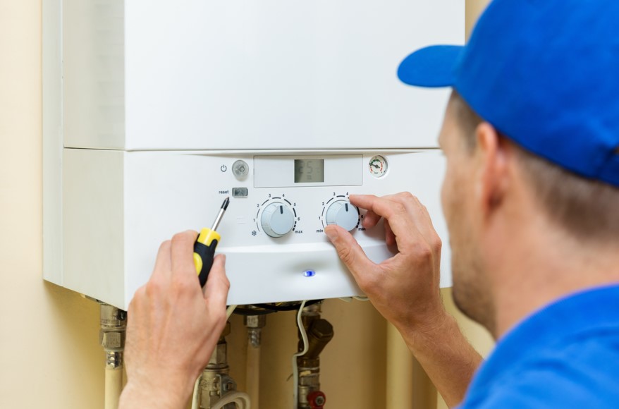 HVAC technician working on a boiler